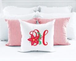 Christmas Poinsettia Alphabet 6 Christmas Poinsettia Alphabet -Embroidery Designs Shop 42 pillowwhitesquareonbedwithredticking3